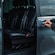 A private driver opening the door of a luxury van